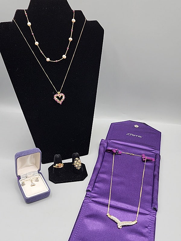 Group of 10k Gold Jewelry-Necklaces and More: Group of 10k Gold Jewelry-Necklaces and More. The group includes a 10k yellow gold and diamond necklace c1990 from JCPenney. featuring a V shaped pendant studded with round and baguette shaped low gra