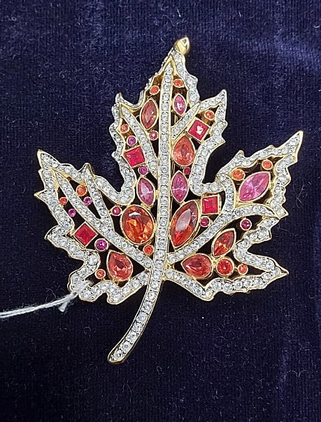 The Autumn Leaf Pin by Nolan Miller: The Autumn Leaf Pin from the All Seasons Pin Collection by Nolan Miller, with COA. This lovely gold tone maple leaf brooch by Nolan Miller features orange, pink, and clear rhinestones in a variety of 