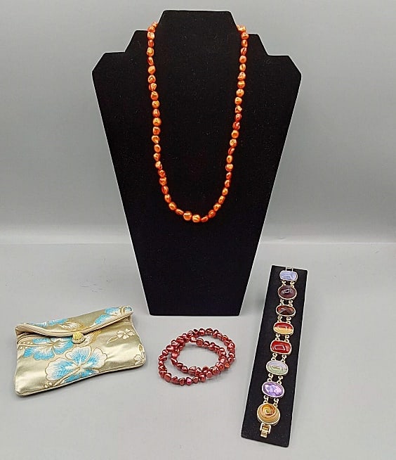 Honora Pearl Set and More: Honora Pearl Set and More. The group includes 1 orange dyed freshwater pearl necklace by Honora measuring 20.5'' long with a silver tone lobster claw clasp closure. In good condition. 2 burgundy dyed 