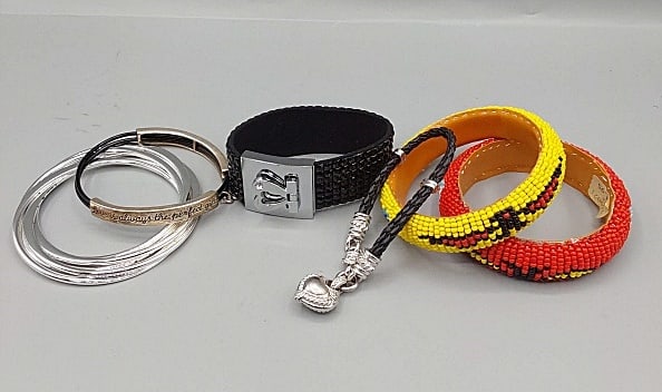 Fashion Bangles and Bracelets-Robert Lee Morris and More: Group of Fashion Bangles and Bracelets-Robert Lee Morris and More. The group includes 5 interlocked silver tone flat bangles by Robert Lee Morris with a 3'' opening. In fair condition with small chips