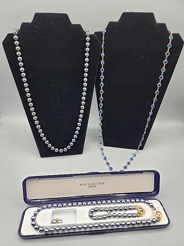 Group of Grey Faux Pearl Necklaces and More: Group of Grey Faux Pearl Necklaces and More. The group includes 1 medium sized dark grey faux pearl hand knotted necklace with a gold tone hook clasp. It measures 30'' long and is in good condition. M