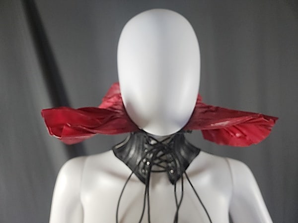 Black Rubber and Red Latex Neck Corset: Y2K Fetish Black Rubber and Red Latex Neck Corset by Gaelyn and Cianfarani. Corset laces up the front, and has 5 silver D rings along the top. Gaelyn and Cianfarani was in business for a few years (cl