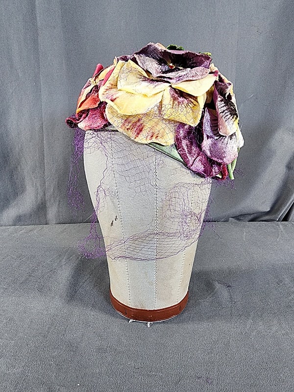 Vintage c1960 Schiaparelli Velvet Pansy Cloche: Vintage c1960 Schiaparelli Velvet Pansy Cloche. This fabulous vintage surrealist inspired floral cloche is covered in larger than life velvet pansies in shades of butter yellow, lavender, and deep pin