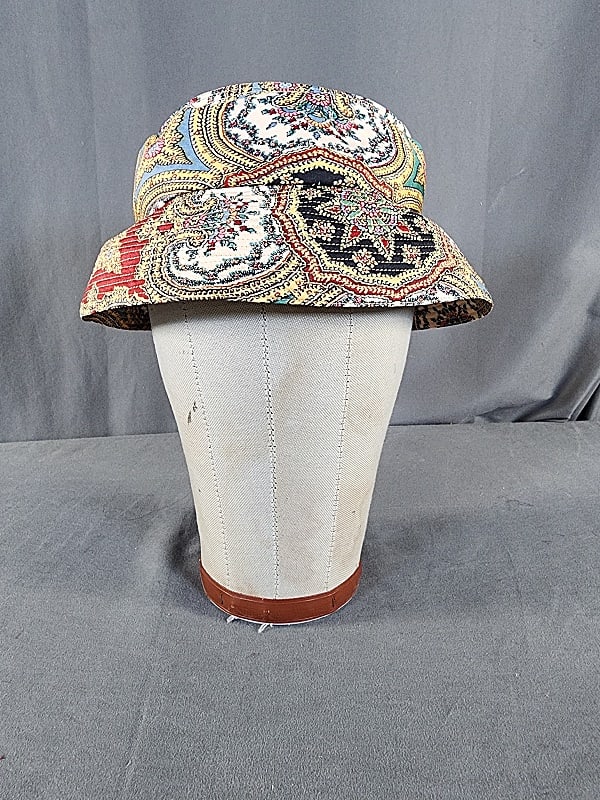 Vintage c1960 Indienne Print Bucket Hat by Norman Norell: Vintage c1960 Indienne Print Bucket Hat by Norman Norell. This vintage colorful Indienne print rayon bucket hat features a tightly stitched body and brim with a matching stiff cross over band. The hat