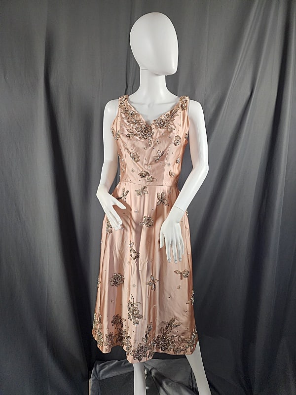 Vintage c1960s Pink Satin Dress: Vintage c1960s pink satin dress with beaded, sequin and rhinestone embellishment. Has V-neck in front along with a scoop neckline at back. Metal zipper with hook & eye closure at back. Tag reads Mason