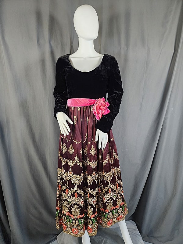 Vintage c1960 Heavily Embellished Evening Gown: Vintage c1960 Heavily Embellished Evening Gown features a long sleeve black velvet bodice with a scoop neckline, a pink velvet ribbon waistband with double looped bows accented with a large artificial