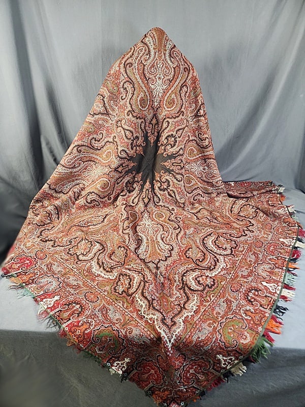 Antique 19th Century Paisley Wool Shawl: Antique 19th Century Paisley Wool Shawl measures 67x70". Small solid black star shaped center field. In good condition with a few very small holes, and overall fringe loss. If you have any doubt, plea