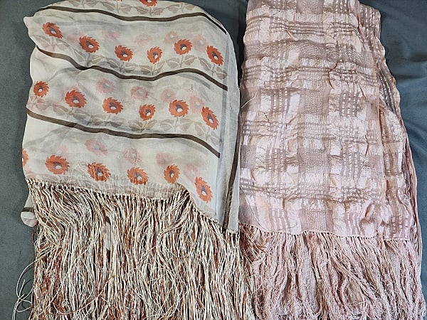 2 Vintage Silk Shawls: 2 Vintage Silk Shawls includes a pink silk shawl with plaid burnout 22x43" with 5" fringe along 2 short sides, fair condition with split by a fringe edge, and another small tear. And an ivory with ora