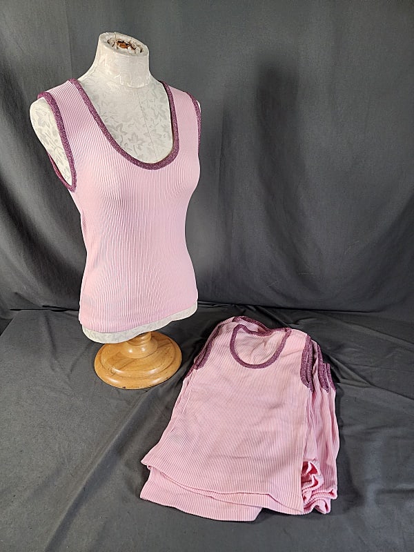 8 1960s Pink Ringer Tees: Old Dead Stock 8 1960s Pink Ringer Tees pink with burgundy neck and sleeve trim. Tag states 100% stretched nylon. They measure 13-15" across the chest laying flat. In overall good condition. If you ha
