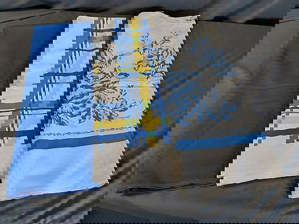 3 Vintage Printed Tablecloths-Blues: Group includes white cotton with blue roses and blue frame, measures 53"x63", several large spots. White cotton with light blue blocks and yellow grid in center and blue and yellow plaid frame, measur