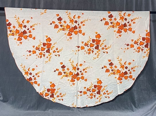 Vintage Printed Tablecloth Oval Orange Ivy: Vintage Printed Tablecloth Oval Orange Ivy. Off-white with orange ivy vines and leaves with orange stitched hem, measuring 49" x 64". In good condition with minor storage discoloration. From the estat