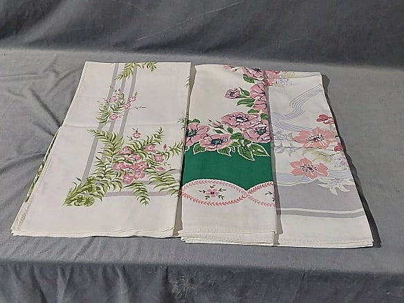 3 Vintage Printed Tablecloths-Pink Flowers: 3 Vintage Printed Tablecloths-Pink Flowers. Includes a white cotton with a pale grey frame with bouquets of Spring flowers in each corner and a light blue ribbon lattice, measures approximately 44 1/2