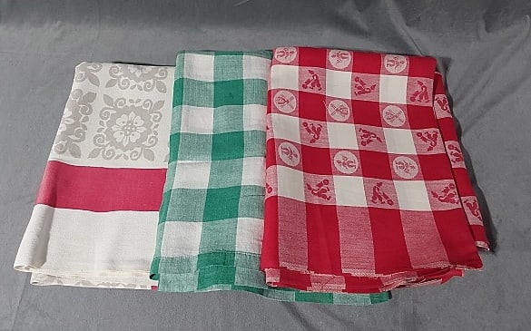 3 Vintage Tablecloths - Plaid: 3 Vintage Tablecloths - Plaid. Group includes a woven green gingham plaid, linen, measures 47" x 60", good condition with large spots. Red gingham plaid with damask dutch motifs, linen, 70" x 90", ver