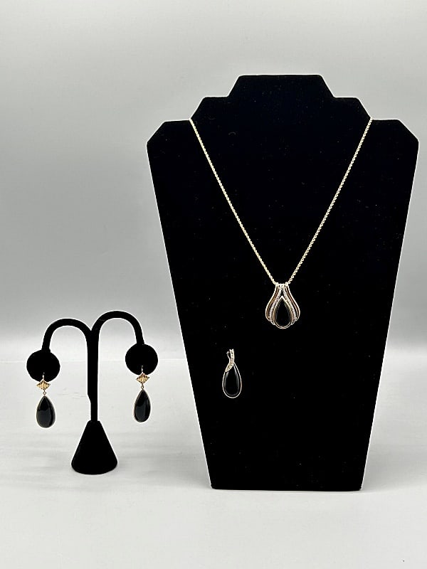 Group of 14K Gold and Onyx Jewelry: Group of 14K Gold and Onyx Jewelry. The group includes 1, 14K yellow gold 18'' long rope chain necklace with a 1.5'' long by 1'' wide 14K yellow and white gold pendant with a 21.2mm long by 10.9mm wid