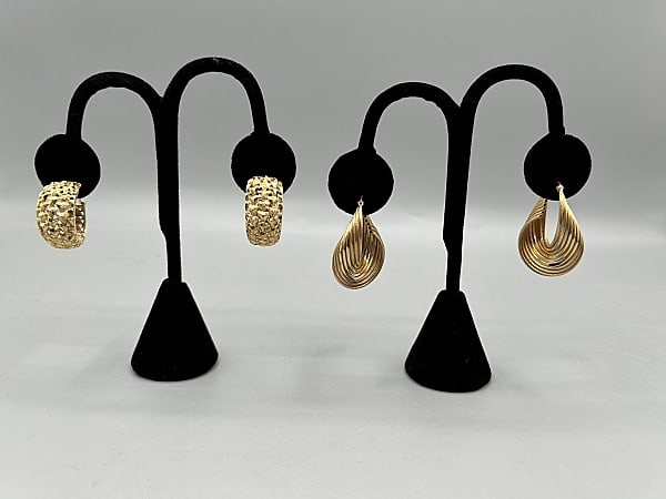 2 Pairs of 14K Yellow Gold Hoops: 2 Pairs of 14K Yellow Gold Hoops. The pairing includes 1 pair of 14K yellow gold stacked and twisted hoops with hinged post snap closures. They measure 1.5'' long by .5'' wide, and together they weigh