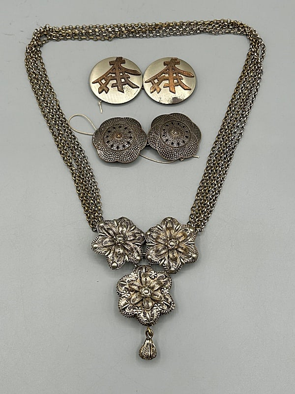 Group of Vintage Silver Tone Buckles and Chain Belt: Group of Vintage Silver Tone Buckles and Chain Belt. The group includes 1 vintage c1950 pair of silver tone geometric floral belt buckles with Indian inspired motifs with single back brackets and a ho