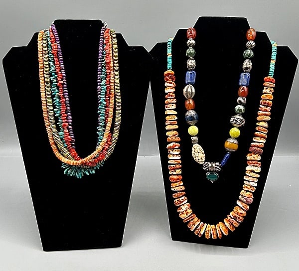 3 Semi Precious Stone and Shell Necklaces: Group of 3 Semi Precious Stone and Shell Necklaces. The group includes 1 handmade 20'' long necklace with a mix of sterling silver beads and gemstone beads in a variety of shapes. There is a mix of la