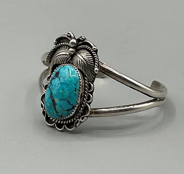 Vintage Navajo Sterling and Turquoise Cuff Bracelet by Simon Yazzie: Vintage Navajo Sterling and Turquoise Cuff Bracelet by Simon Yazzie. This vintage Navajo cuff bracelet by Simon Yazzie features double domed bar shoulders with a large center natural turquoise cabocho