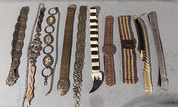 10 Ladies Fashion Belts- Metal and Bone: Group of 10 Ladies Fashion Belts- Metal and Bone. The group includes 10 modern ladies adjustable fashion belts. featuring 5 metallic armor like belts with embossed metal plates mounted on black elasti