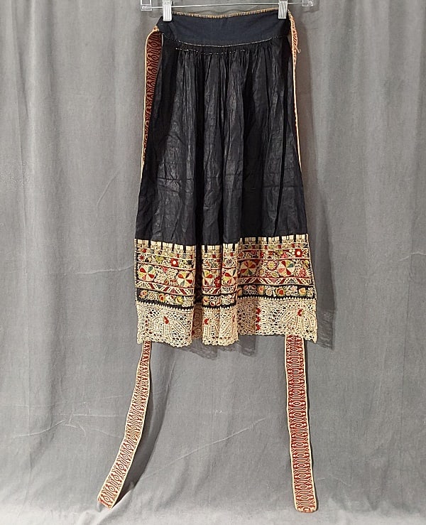 Antique c1880 Czech Embroidered Glazed Cotton Apron: Antique c1880 Czech Embroidered Glazed Cotton Apron. This antique c1880 Czech black glazed cotton apron features a beautifully bottom border in a mix of geometric and floral horizontal bands in a mix 