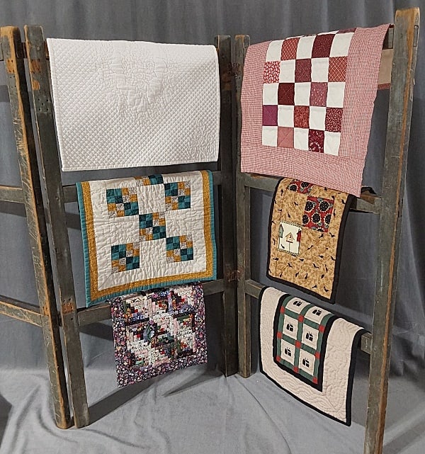 6 Doll Quilts c1980-2001: Group of 6 Mini Doll Quilts c1980-2001. The group includes 6 doll quilts from the collection of Bobbie Aug. It includes 1 small doll quilt made by Caroline Peterson featuring a country black bird them