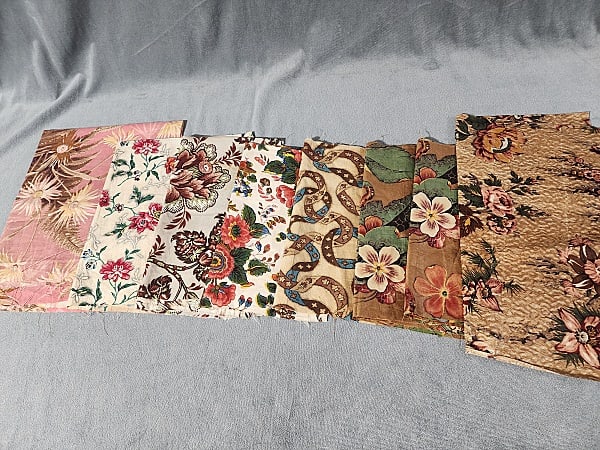 8 Pieces of 19th Century Floral Chintz: 8 Pieces of 19th Century Floral Chintz. The group includes 8 pieces of 19th century floral chintz. Featuring 1 pink, yellow, and brown floral chintz with bunches of daisies and ferns. It measures 22''