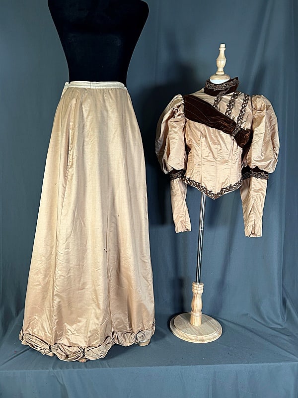 19th Century Tan/Brown Silk Promenade Dress c1880: 19th Century Tan/Brown Silk Promenade Dress c1880. The lot includes a matching bodice and skirt. Featuring a bodice in tan silk with puffed sleeves, brown velvet trim at the neck, elbows, and across t