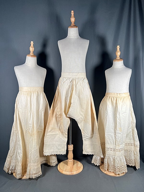Group of 2, 19th Century Ladies Petticoats and More: Pair of 2, 19th Century Ladies Petticoats and More. The group includes 3 cotton 19th century petticoats, featuring 1 with a plain body and a hem embellished with small pickups, gathers, embroidered bo