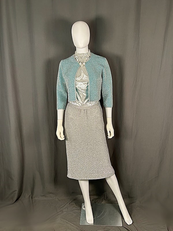 c1960 Metallic Knit Cardigan and Skirt: c1960 Metallic Knit Cardigan and Skirt set. The lot includes 1 vintage c1960 Italian made knit turquoise wool and silver tinsel knit cardigan by Anne Rubin Imports featuring a rhinestone button closur