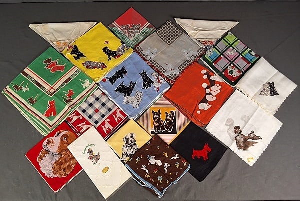 18 c1950 Dog Themed Hankies: 18 c1950 Dog Themed Hankies.The lot includes 18 vintage c1950 dog themed hankies featuring a variety of decorations such as printing, machine embroidery, and cross stitch. They range in size from 9'' 
