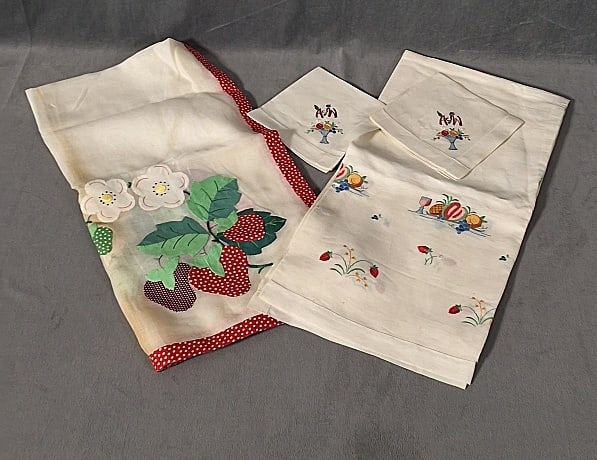 2 Vintage Linen Tablecloths and Napkins - Fruit: 2 Linen Tablecloths and Napkins - Fruit. Includes a white linen tablecloth with a red and white polka dot cotton border with clusters of appliqued strawberries in each corner, measuring 40" x 40", in