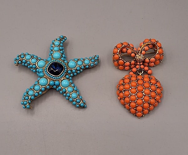 Pair of Brooches-Joan Rivers/Kenneth Jay Lane: Pair of Brooches-Joan Rivers/Kenneth Jay Lane. The lot includes 2 modern brooches, including 1 Victorian Sweetheart brooch by Joan Rivers featuring coral colored cabochons in a bow and dangling inflat