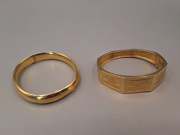Pair of Mid Century 14K Gold Bangles: Pair of Mid Century 14K Gold Bangles. The lot includes 2 mid century 14K yellow gold bangles featuring 1 hollow 14K domed hinged bangle with decorative etched designs along the top. It weighs 15.41 gr