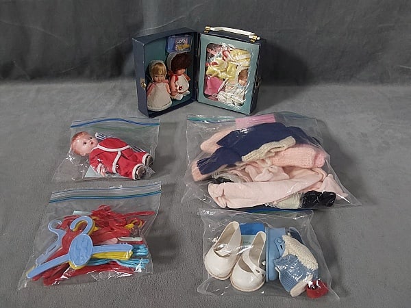 Three Uneeda Doll Company Mini Dolls and More!: Three Uneeda Doll Company mini dolls marked 1966 with wardrobe, comb, brush and bracelets and case. Clothing includes pajamas, coat, hand made sweaters, and a dress. One is a Baby Peewee; Rattle doll;
