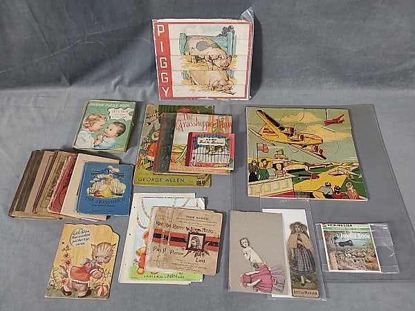 Large Mixed Lot of Children's Ephemera: Large Mixed Lot of Children's Ephemera. The lot includes a large mix of vintage and antique children's related ephemera. Featuring 1 vintage complete wooden puzzle, 1 vintage piggy puzzle, 1 1952 copy