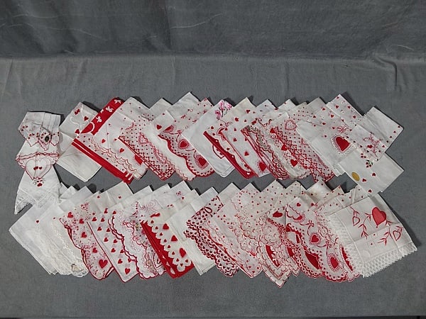 36 Vintage Valentine's Themed Hankies: 36 Vintage Valentine's Themed Hankies. The lot includes 36 vintage Valentines themed cotton hankies all measuring 13'' x 13'' and featuring a variety of decorations such as printing, machine embroider