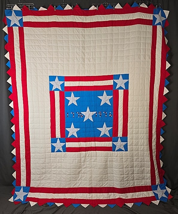 Vintage Bicentennial Medallion Quilt: Vintage Bicentennial Medallion Quilt measuring 84x102". Blue center with 5 white appliqued stars and the dates 1776 and 1976 formed in small red white and blue stars. There is a triple border in red, 