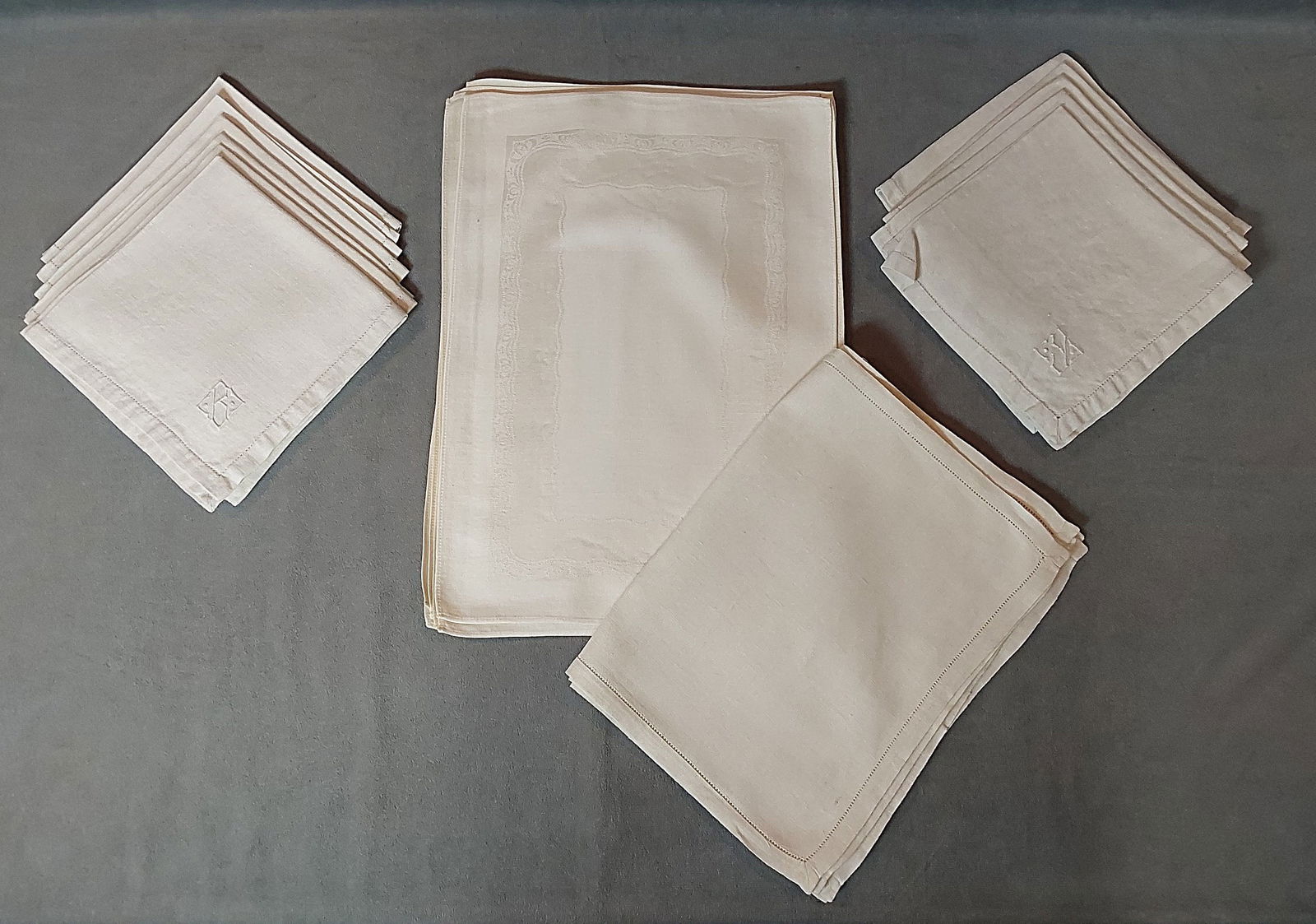 2 Vintage Placemat Sets and More: 2 Vintage Placemat Sets and More. The lot includes 2 vintage sets of placemats and more, featuring a set of 8 vintage cotton/rayon blend damask placemats with an undulating border. In good condition w