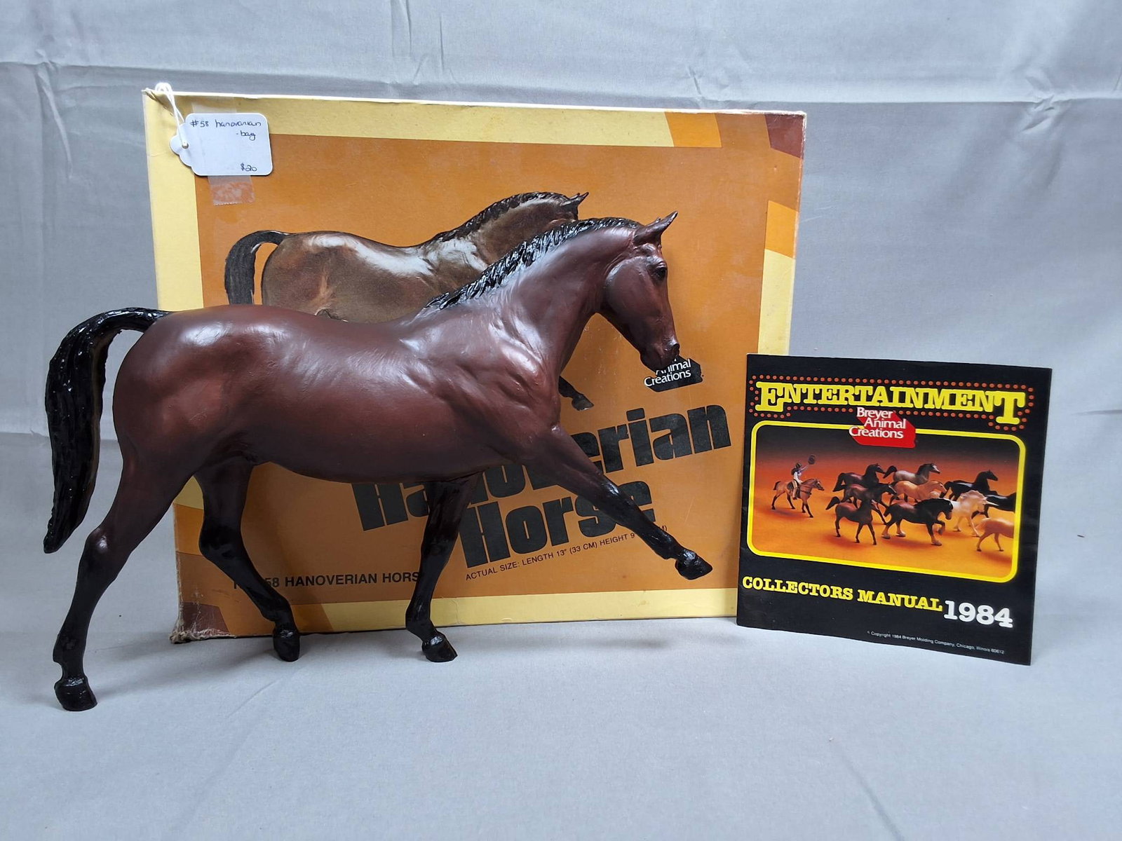 Breyer Hanoverian Horse #58 with 1984 Catalog: Breyer Hanoverian Horse #58. Traditional Hanoverian mold in original bay finish. In good condition with minor hoof rubs. The lot comes with the original brown picture box, which shows damage, includin