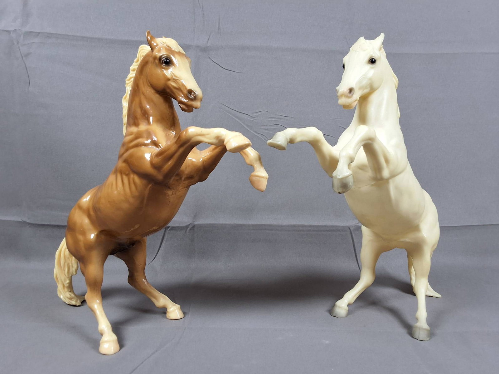 Breyer #33 King Glossy Palomino and #30 King Semi-Glossy Alabaster Fighting Stallions: Pair of Breyer Fighting Stallions featuring #33 King in glossy palomino with bald face, white points, and grey-shaded genitalia, and #30 King in semi-glossy alabaster with white mane and tail, produce
