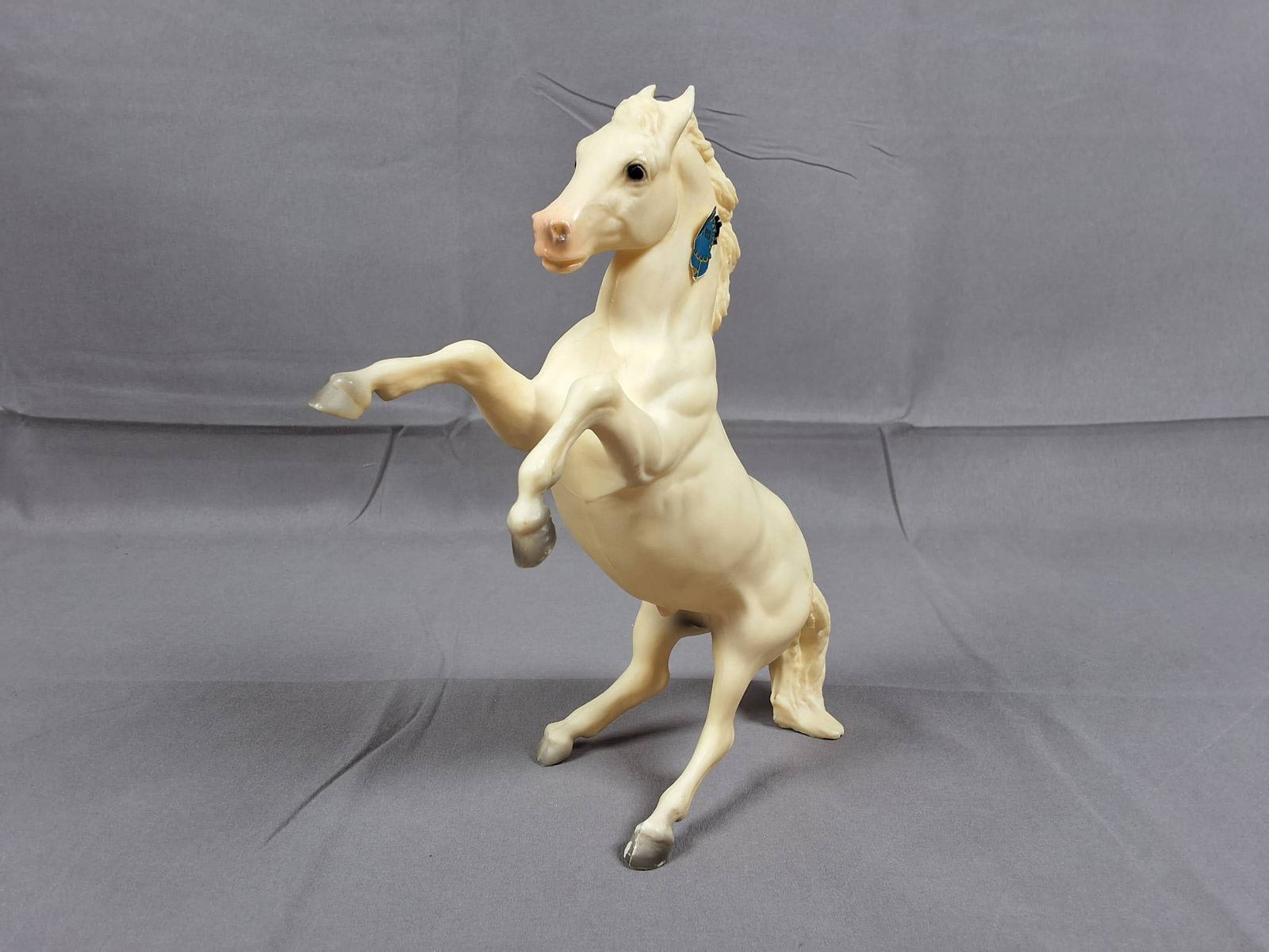 Breyer #180 Rex 1965-1976 - Alabaster Lipizzan: Breyer #180 Rex model of a Lipizzan horse with alabaster body, white mane and tail. Manufactured between 1965-1976 and 1978-1985. Features include the original blue ribbon sticker and raised Breyer in