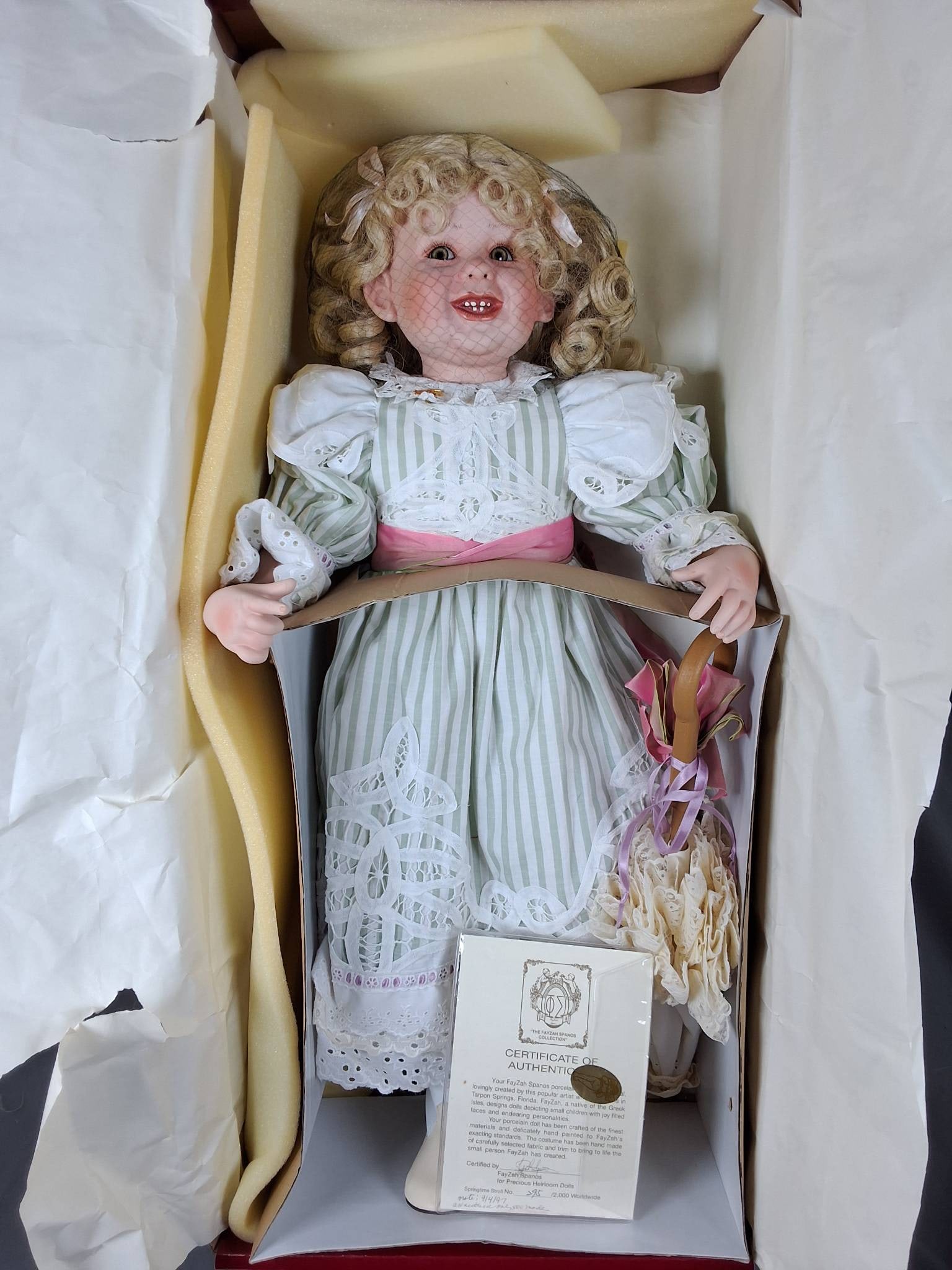 Spring Time Stroll by FayZah Spanos: Spring Time Stroll porcelain doll, designed by FayZah Spanos for Precious Heirloom Dolls. She measures 27'' tall and is #295 out of 2000 produced. The doll is dressed in a green striped dress adorned 