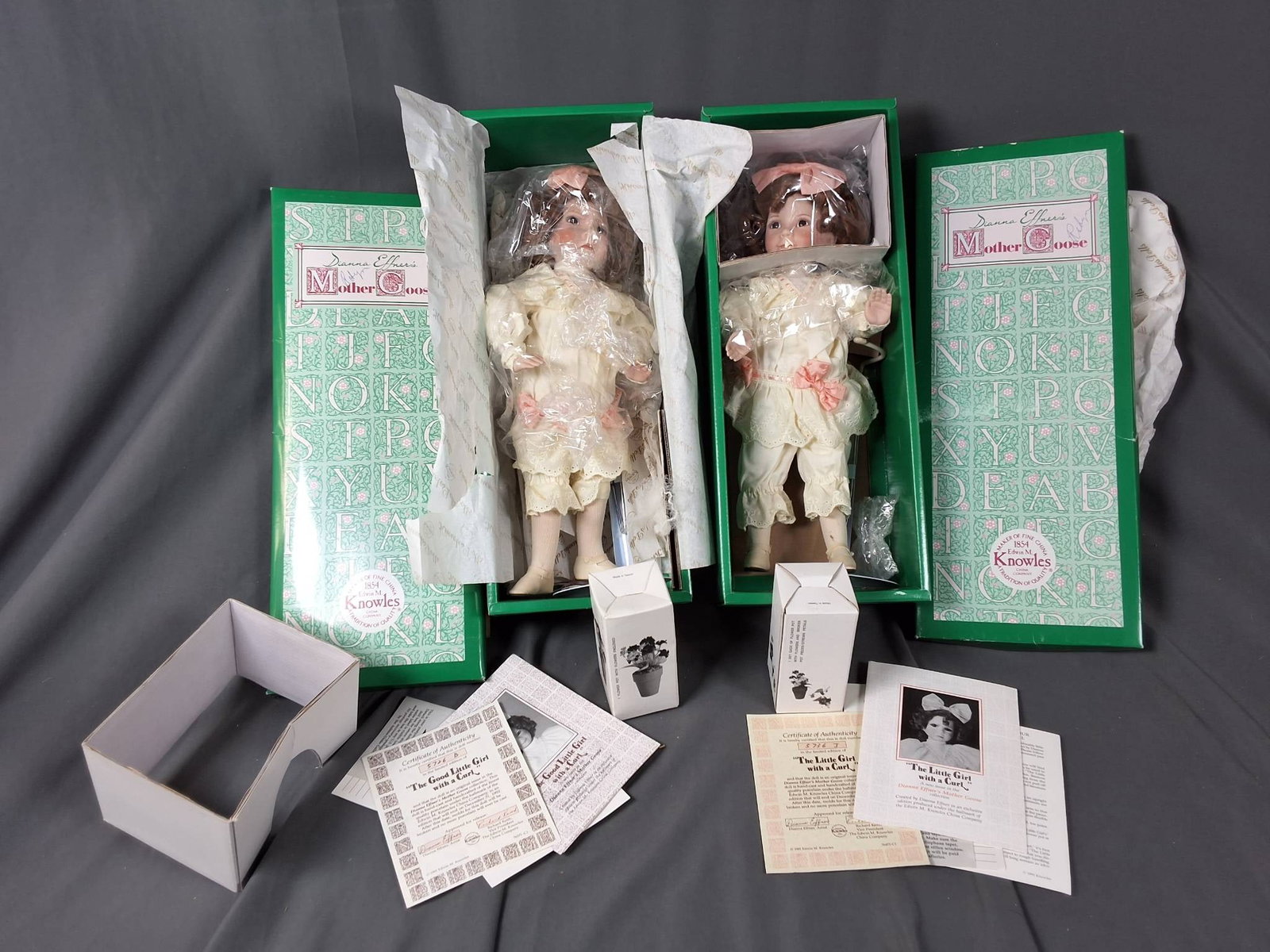 2 Little Girl with a Curl by Diana Effner ?: Includes 2 dolls with porcelain heads and hands. Produced in conjunction with the Knowles China Company as part of the Mother Goose Collection. Each doll is dressed in a pale, cream-colored outfit emb