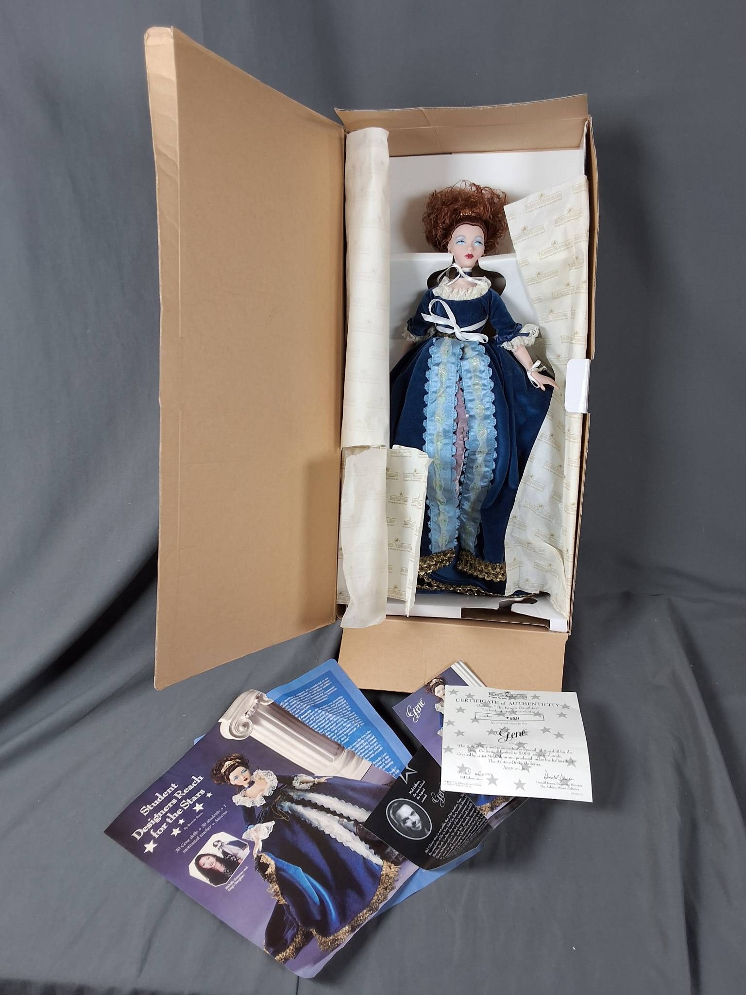 Gene in The King's Daughter: Gene in The King's Daughter This doll stands 18 inches tall and is part of a limited collection: 4421/5000. It features elaborate attire consisting of a deep blue velvet gown accented by white lace de