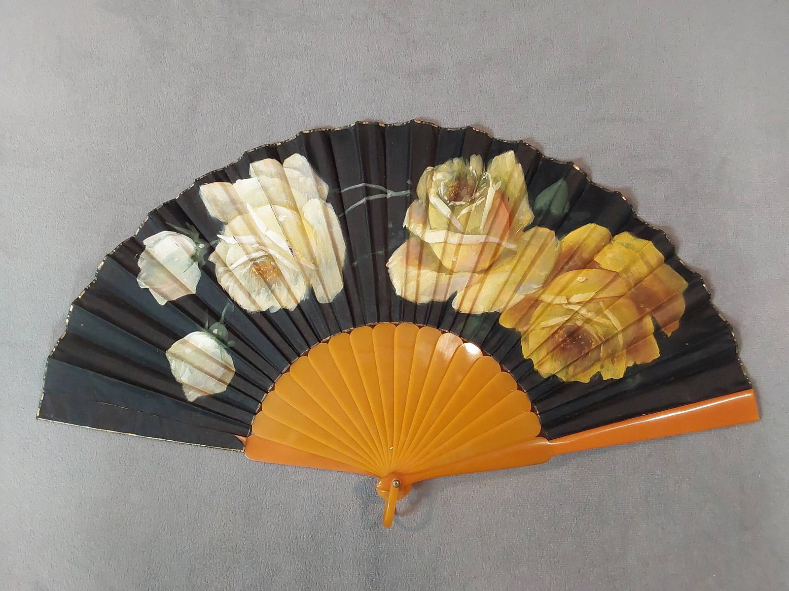 Antique Folding Fan - Hand-Painted Floral Design and Galalith Guards: Antique folding fan featuring hand-painted yellow roses on the front, with orange-tone guard and ribs. The note included in the box suggests these may be made from galalith, an early plastic derived f