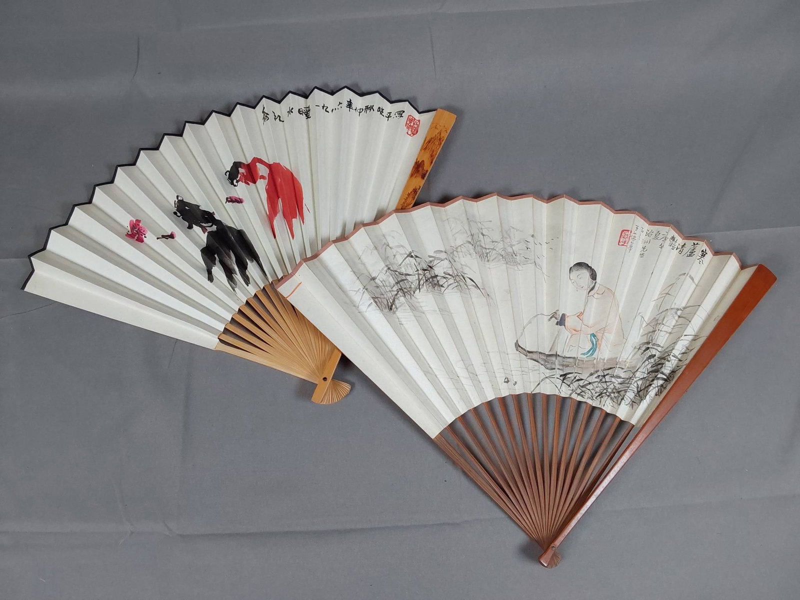 Vintage Asian Rice Paper Folding Fans - Hand-Painted Designs: Lot includes two vintage Asian rice paper bamboo folding fans. Both fans are hand-painted on paper and are double-sided. Both fans feature characters likely forming a poem on the reverse side. While o
