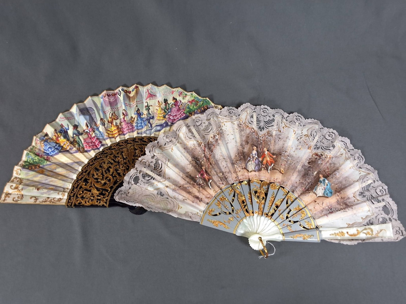 2 Hand Painted Souvenir Fans -Navy Blue and White: 2 vintage hand painted souvenir fans. The navy blue fan features a hand painted cotton scene of flamenco dancers in a plaza with scrollwork accents on wooden ribs and guards with gold painted details.