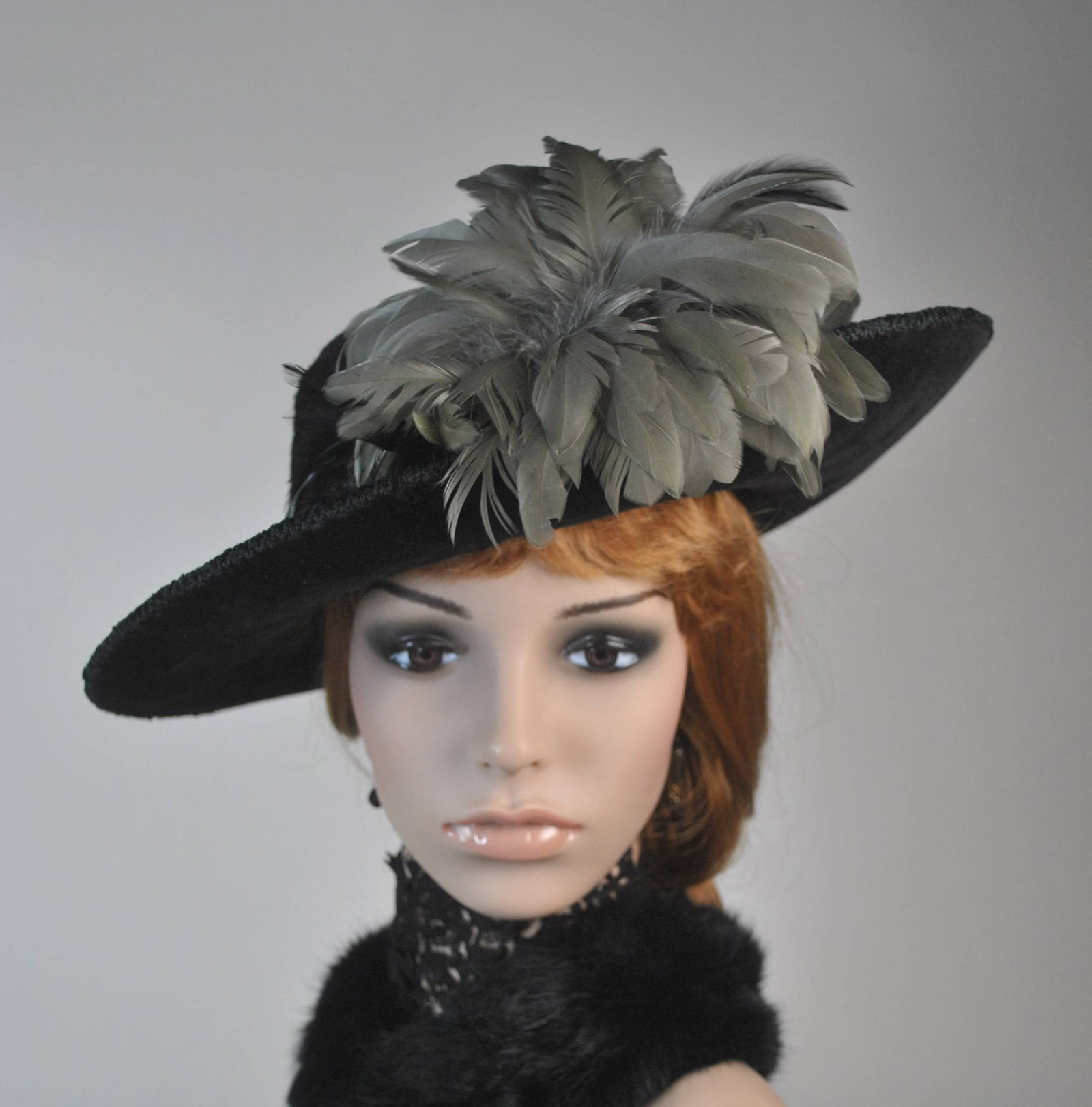 Antique Black Velvet Hat: Antique 1910s black velvet medium wide brim hat that is approximately 23 inches. The hat showcases a ring of shiny black feathers circling the brim and is adorned with gray woven cord trim along its t