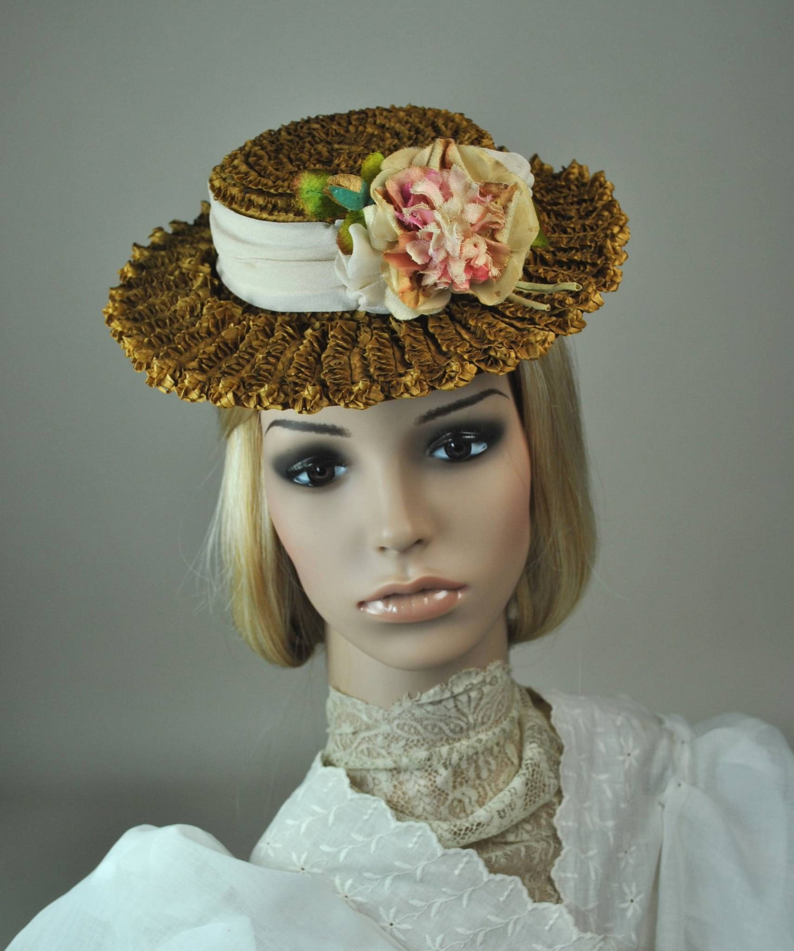 Restored Antique Straw Perching Hat: The hat is an antique small natural-colored straw boater style, featuring a cream-colored silk chiffon band and under brim. A pink and cream flower with a bud adds detail, with horsehair for attaching