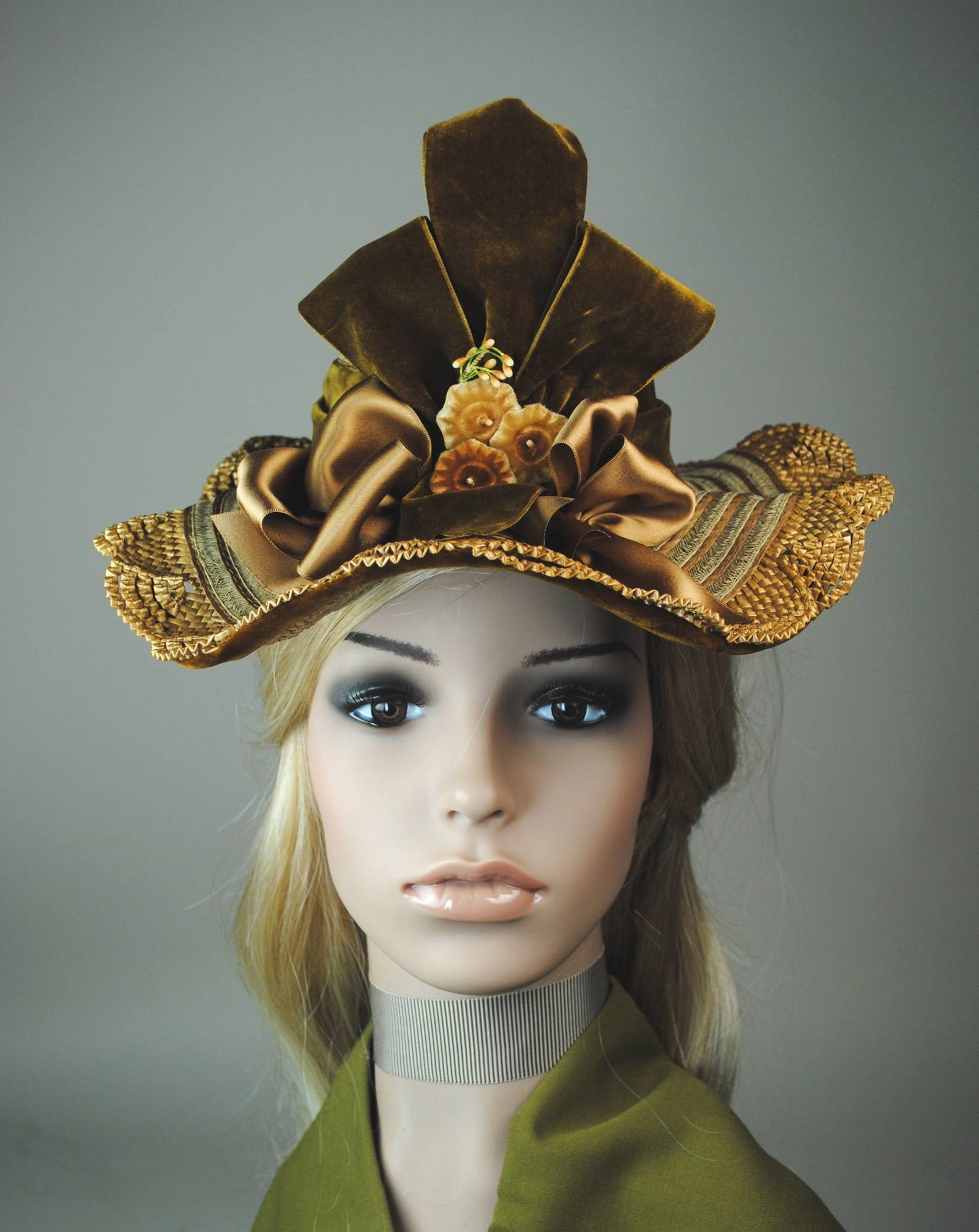 Antique Straw Hat - Velvet Bow: Antique natural straw hat. The hat showcases a small flat-top crown and a fluted brim, adorned with a rust-brown velvet ribbon and tan satin ribbon loops. Horsehair tabs provide an anchoring detail, c